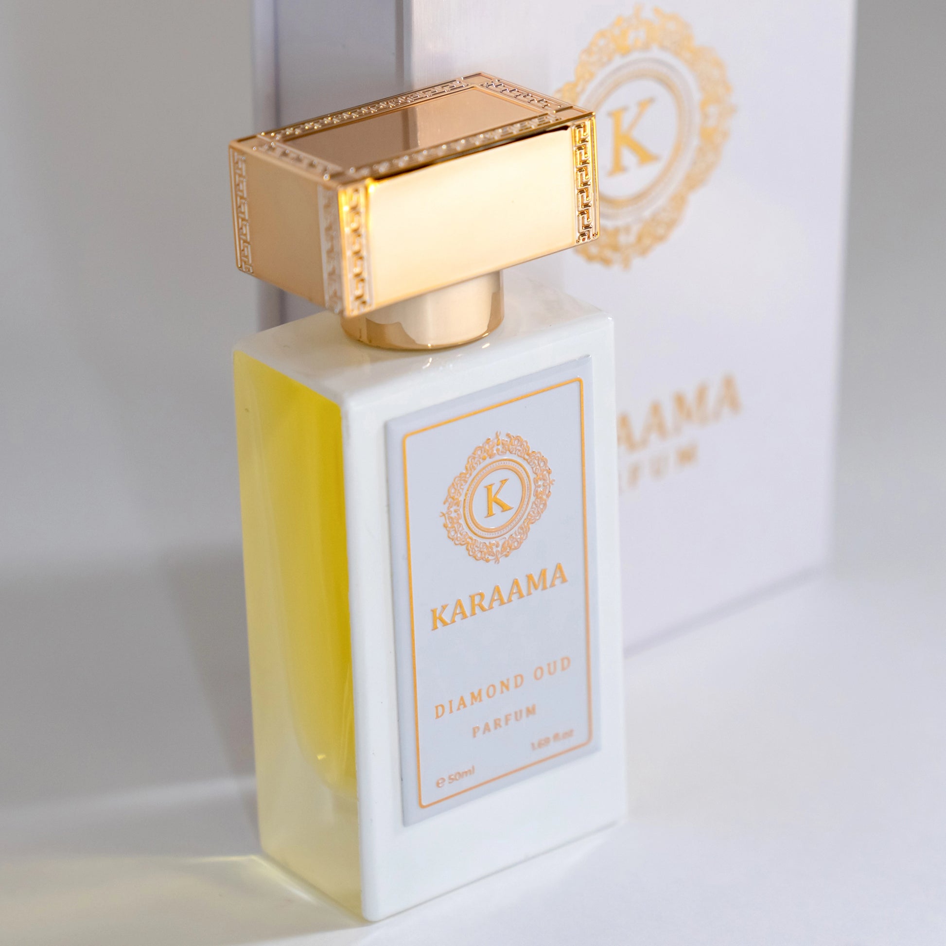 Elegant KARAAMA Diamond Oud Parfum showcased beside its box, featuring a golden cap and luxurious branding. Perfect for scent aficionados seeking a trending, high-class fragrance. #LuxuryPerfume #DiamondOud #KARAAMA #ScentTrend #EleganceInABottle
