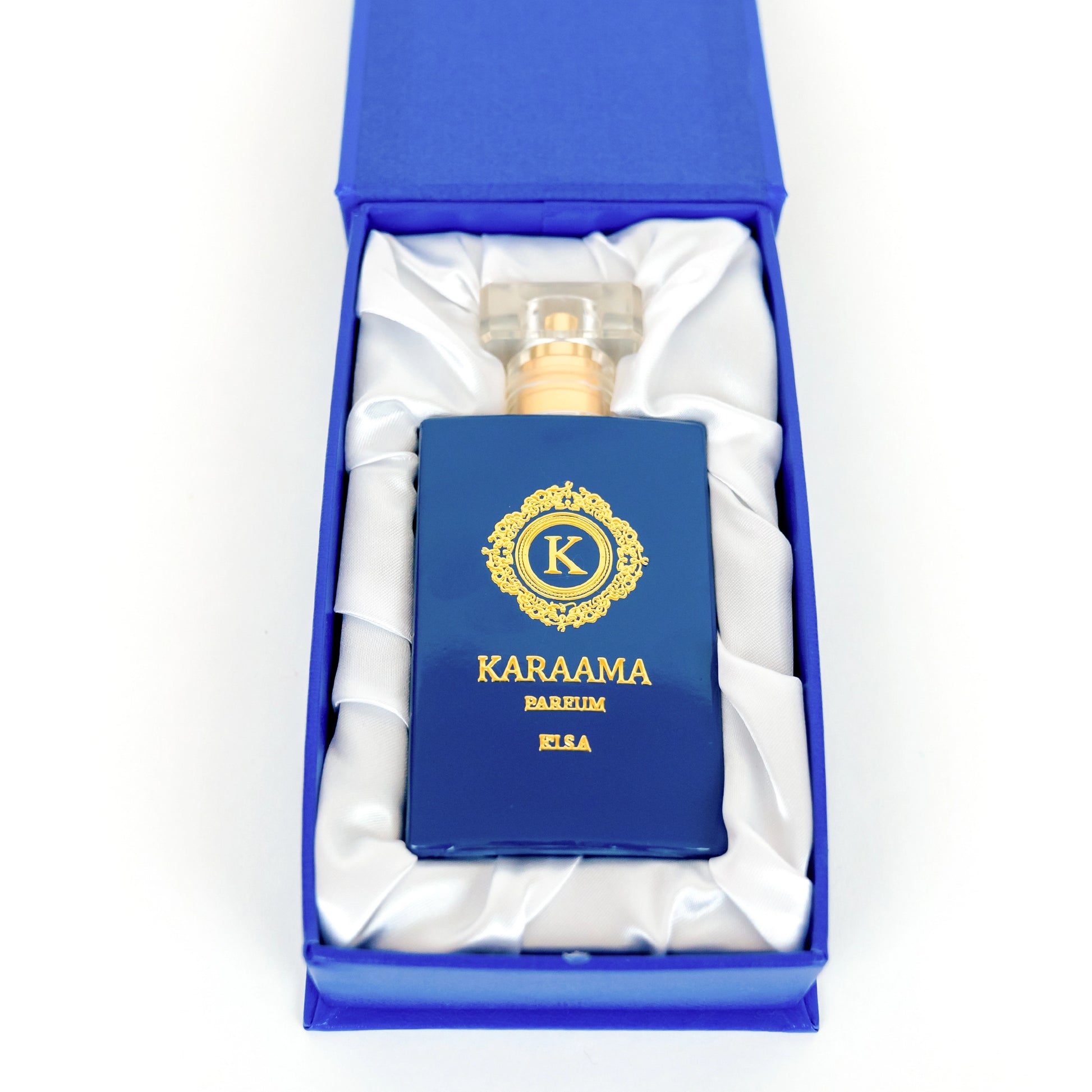 Elegant KARAAMA perfume bottle with regal blue and gold design, presented in a satin-lined luxury box, embodying sophistication and style for a perfect gift item. #luxuryfragrance #elegantgift #perfumebox #sophisticatedstyle #trendingbeauty
