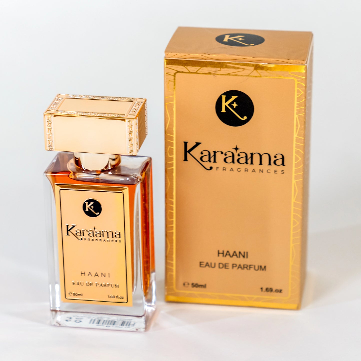 Experience the elegance of Karāama Fragrances' Haani Eau de Parfum, showcased in a luxurious glass bottle with golden accents, next to its chic packaging.