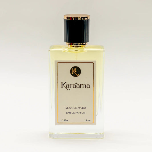 A bottle of Karaama Musk de Wood Eau de Parfum with a gold lid on a white table. The bottle is 50ml or 1.69 fl oz. [karaama.com]