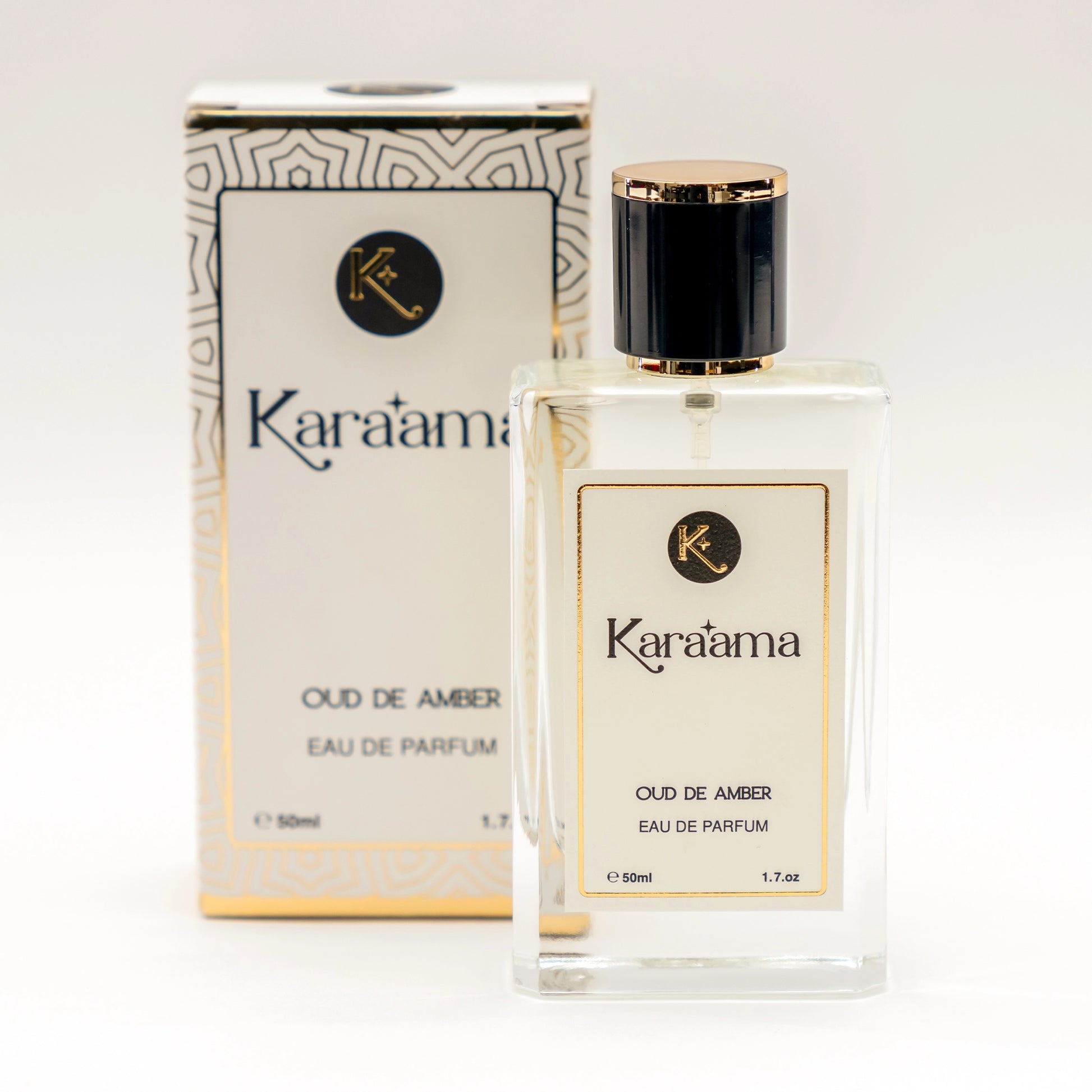 A bottle of Karaama Oud de Amber Eau de Parfum with a gold lid on a white table. The bottle is 50ml or 1.69 fl oz. [karaama.com]