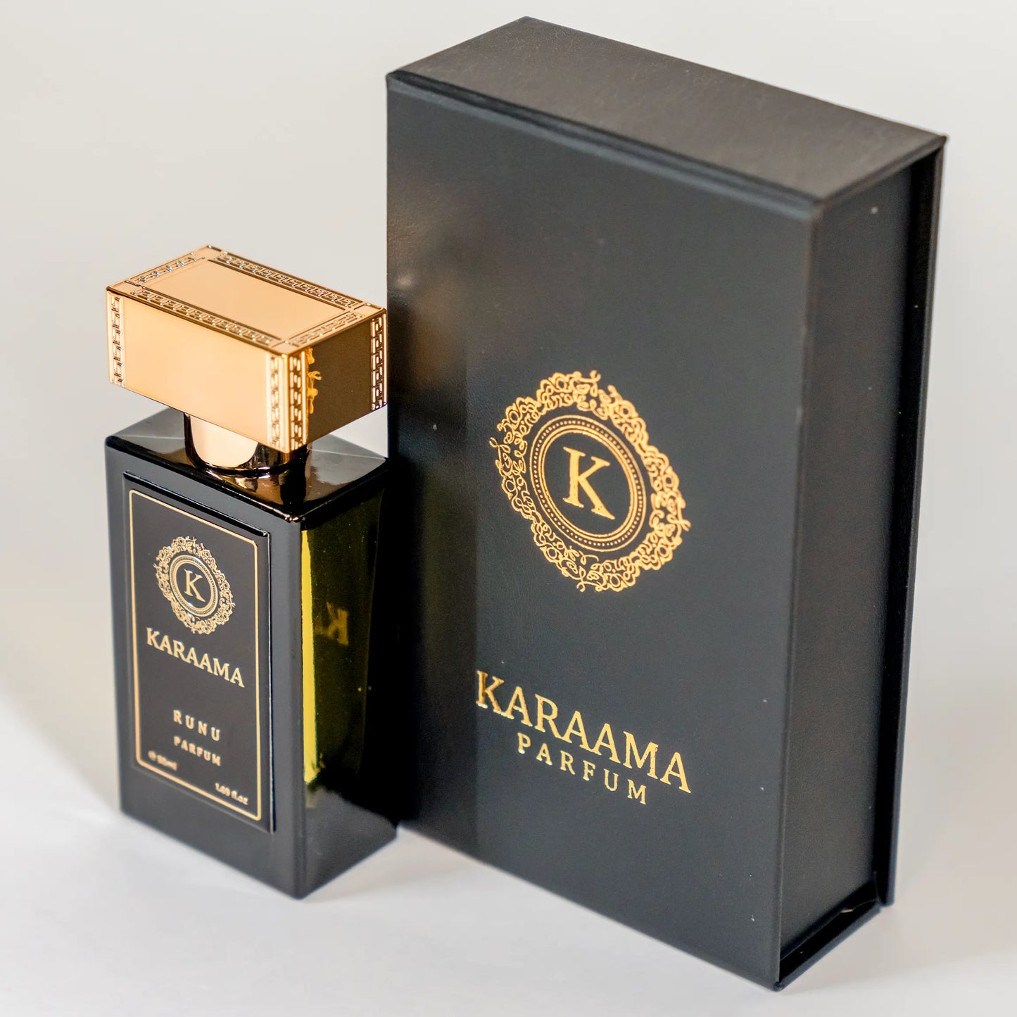 A bottle of Karaama Runu Parfum with a gold lid on a white table. The bottle is 50ml or 1.69 fl oz. [karaama.com]