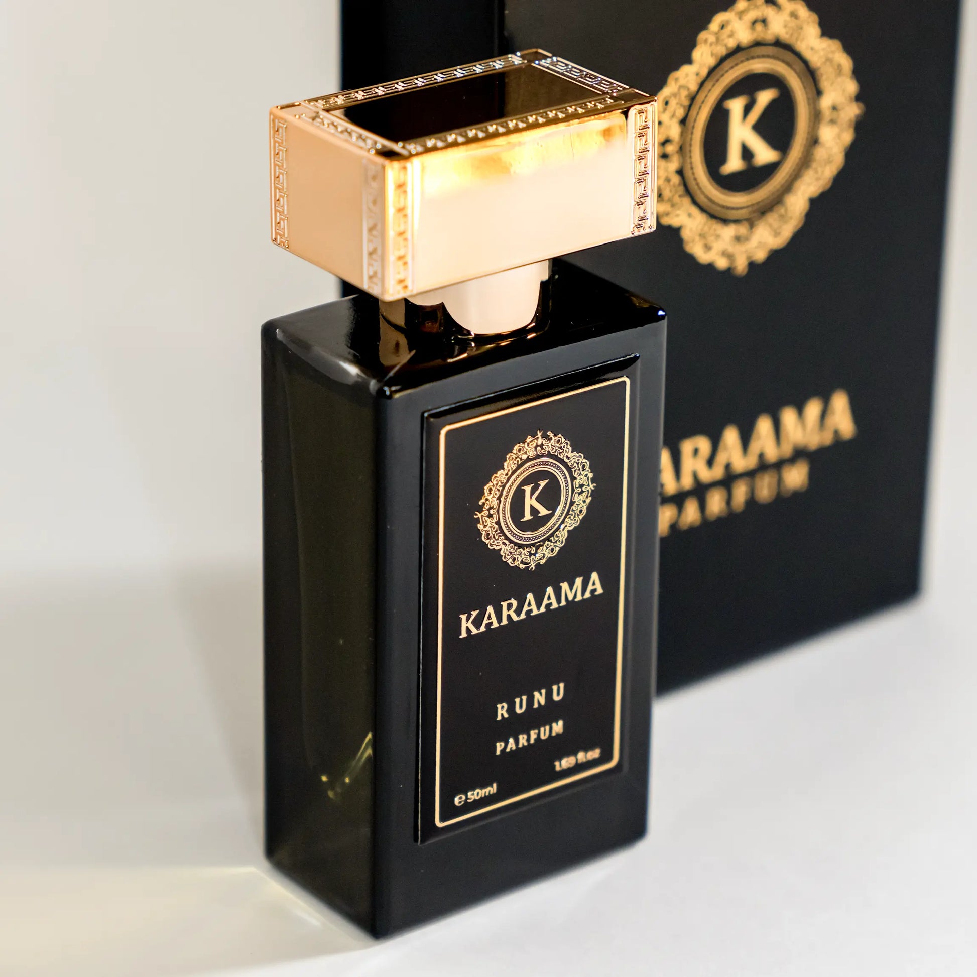 A bottle of Karaama Runu Parfum with a gold lid on a white table. The bottle is 50ml or 1.69 fl oz. [karaama.com]